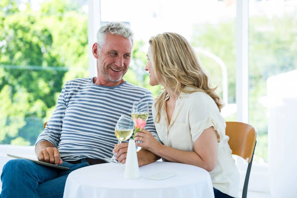 Smiling mature couple having wine lifestyle at Sierra Sol Mobile Homes For Sale Sparks
